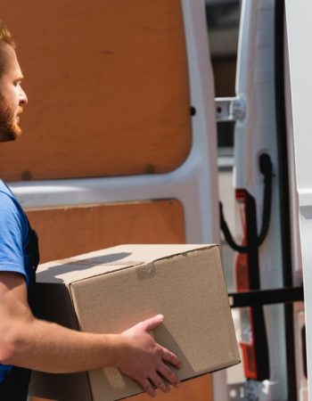 side-view-of-loader-holding-package-near-truck-on-2023-11-27-05-32-57-utc-1024x684